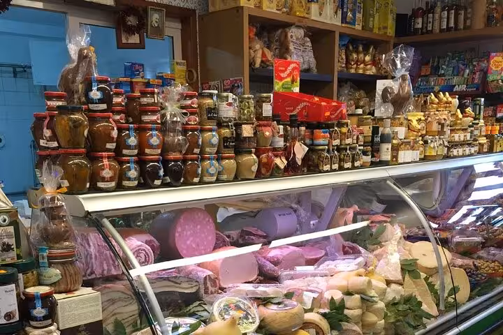 Traditional Italian deli with cured meats and artisanal jars, a highlight of the Sorrento food and limoncello tour.