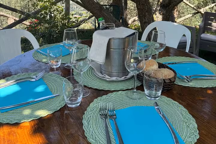 Enjoy a rustic outdoor dining setup in Sorrento, featuring elegant tableware for a traditional Italian lunch experience.