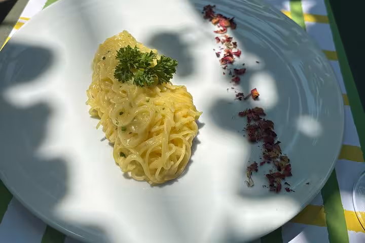 A plate of creamy lemon-infused pasta garnished with parsley, beautifully presented at the Sorrento tasting experience.