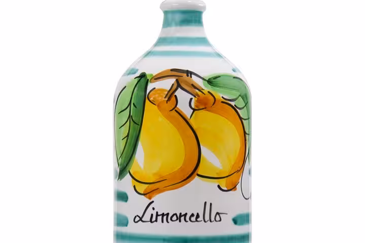 Close-up of a decorative limoncello bottle with vibrant lemon artwork, highlighting Sorrento's famous citrus liqueur.