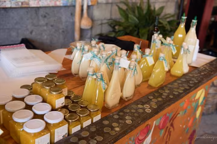 Handcrafted limoncello and lemon curd displayed at a local market in Sorrento, perfect for a Hercolaneum tour stop.