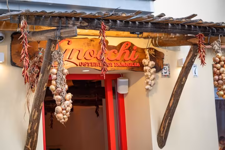 Charming entrance of a Sorrento osteria adorned with garlic and peppers, part of the Bites & Sips Tour experience.