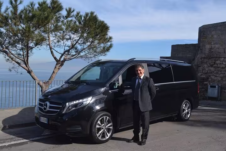 Private transfer service from Sorrento to Positano with a luxury black Mercedes van and professional driver.