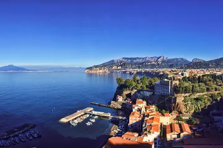 Aerial view of Sorrento's stunning coastline with vibrant blue waters and lush cliffs, perfect for a private boat tour.