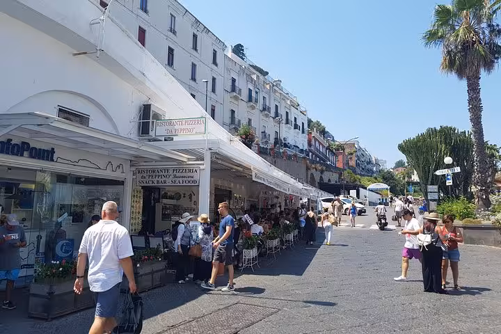 Sorrento waterfront promenade with cafes and tourists, included in 6-day private Amalfi Coast tour from Rome