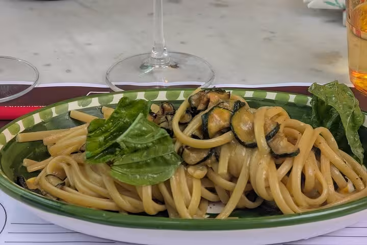 Enjoy zucchini pasta with fresh basil in a semi-private Sorrento wine pairing lunch under lemon trees.