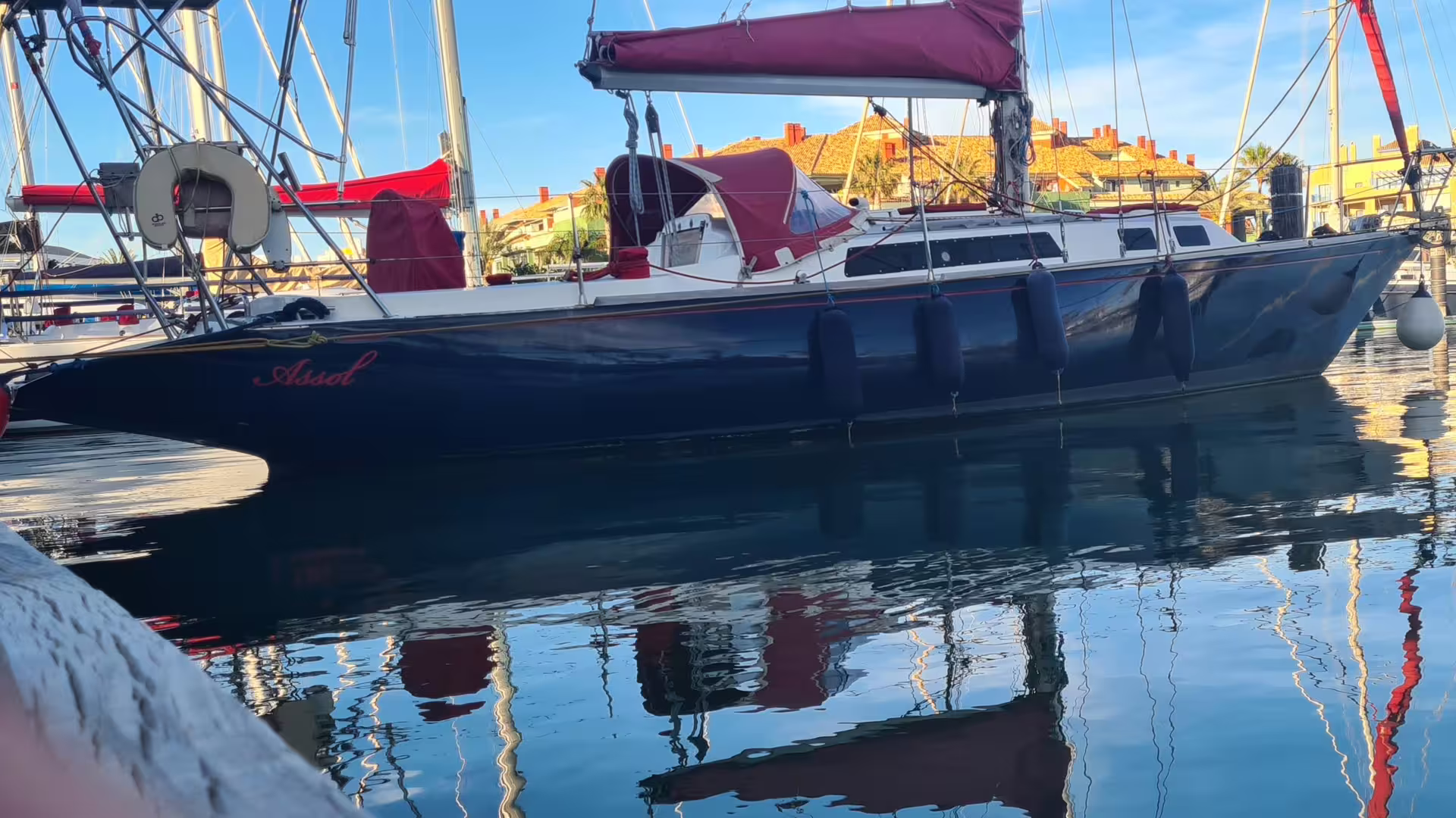 Elegant sailboat docked in Sotogrande marina, perfect for private boat charters for groups of eight.