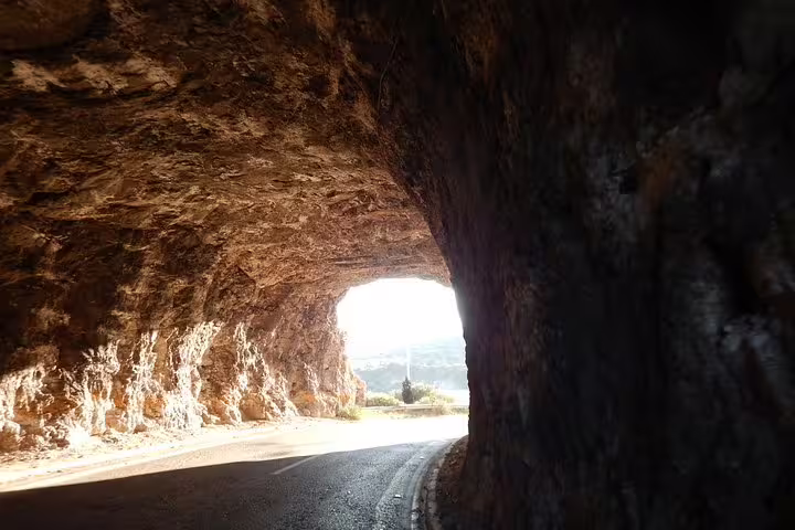 Coastal road tunnel carved in rock on the Athens Riviera, a scenic drive on the Sounion sunset private tour