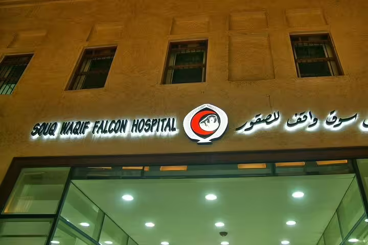 Exterior of Souq Waqif Falcon Hospital illuminated at night, a unique stop in Doha Transit City Tour from Hamad Airport.