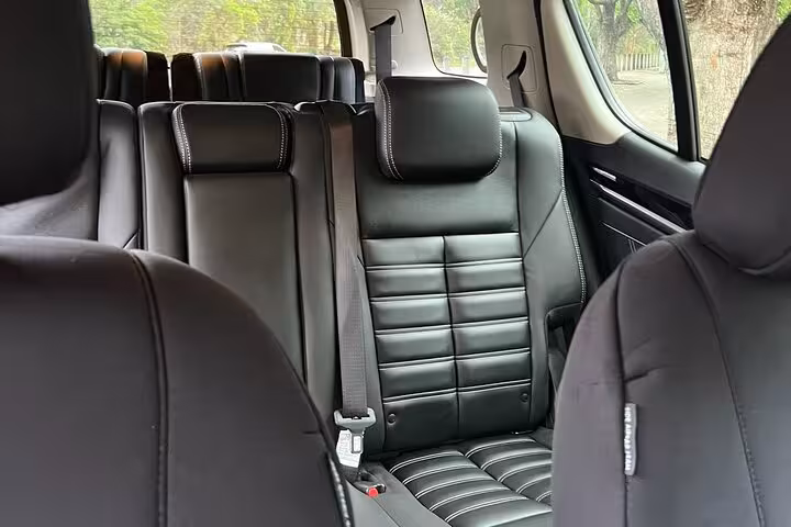 Spacious luxury SUV interior with black leather seats for South Coast private group tour comfort.