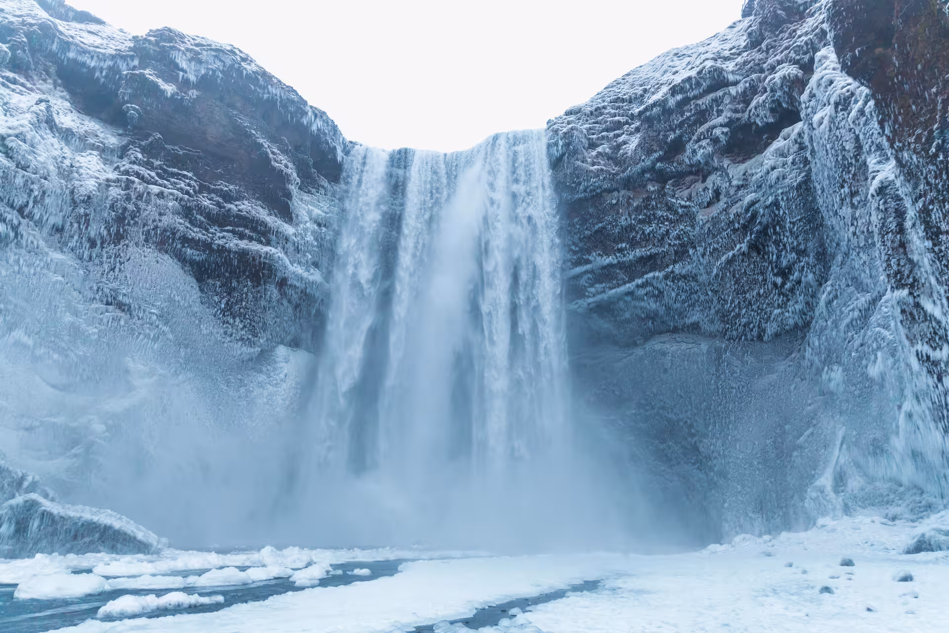 Winter view of Skogafoss waterfall on South Coast Adventure Rally Car Edition, Iceland icy spray and frozen river