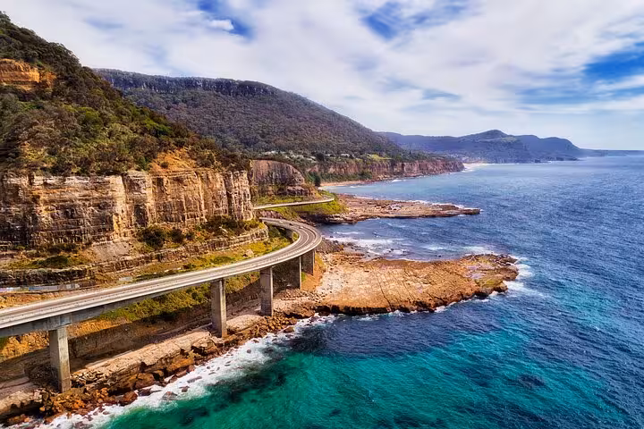 Scenic coastal road on the South Coast offering breathtaking ocean views, perfect for a private daily group tour.