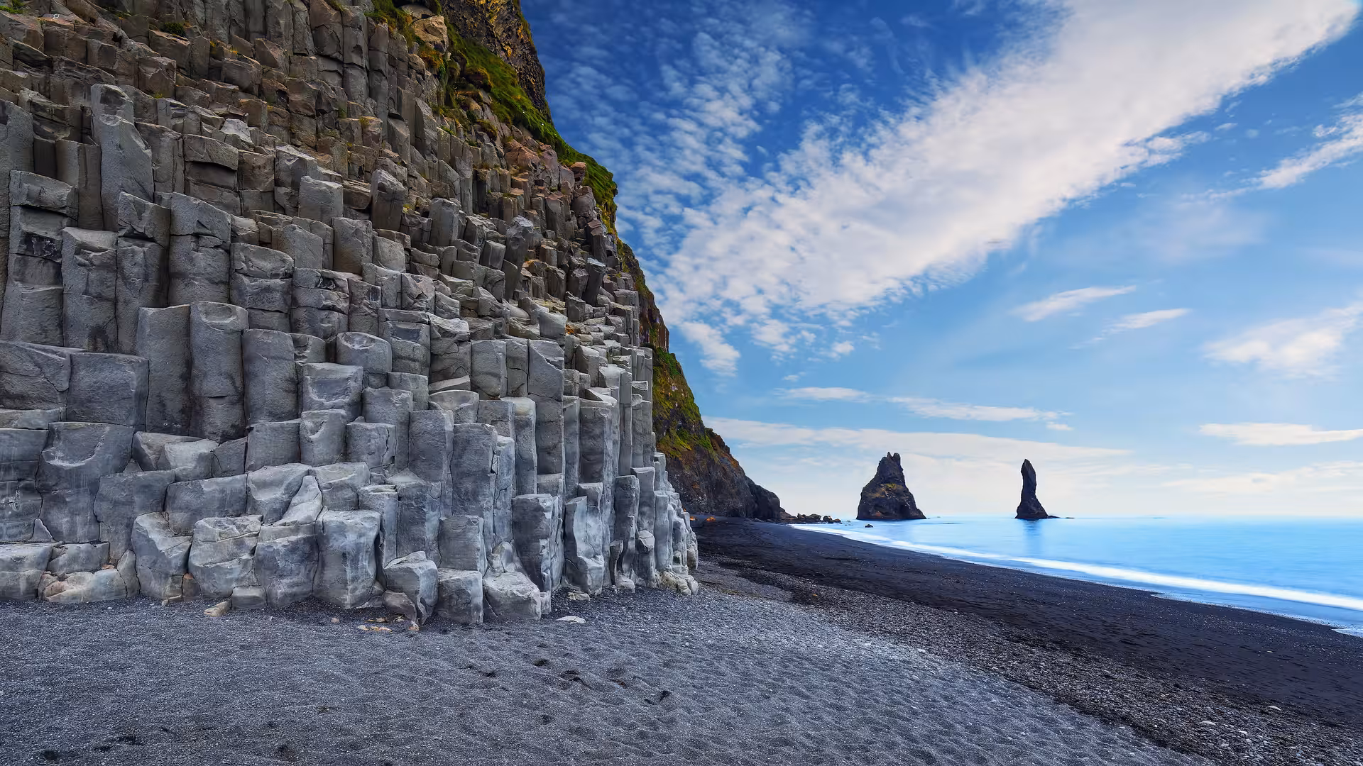 Dramatic basalt columns and black sand beach at Reynisfjara, a must-see on the South Shore adventure.