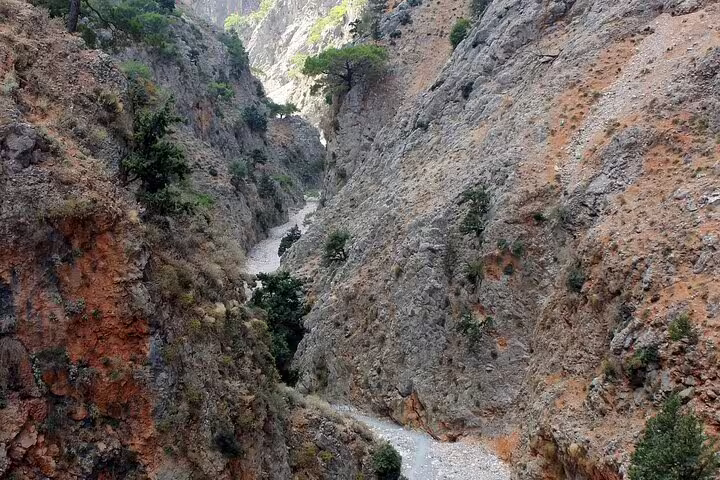 Rugged gorge with rocky cliffs and sparse vegetation on the hiking trail in Southwest Crete.