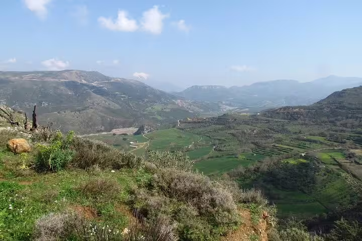 Expansive valley views with terraced hills and distant mountains in Southwest Crete, perfect for hiking adventures.