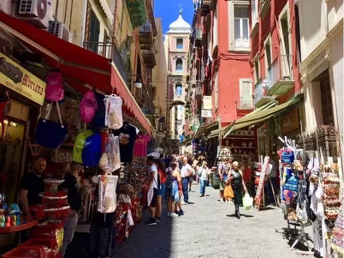 Spaccanapoli street market scene on Naples daylight walking tour, colorful shops and local crowds