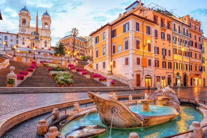 Spanish Steps and Barcaccia Fountain in Rome at sunrise, colorful flowers and family-friendly walking tour meeting point