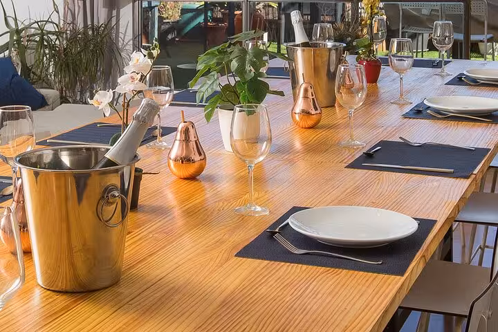 Elegant table setting for a Spanish tapas cooking class in Barcelona, featuring wine glasses and decorative elements.