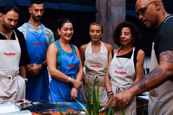 Participants enjoying an interactive Spanish tapas cooking class in Barcelona, focusing on authentic culinary skills.