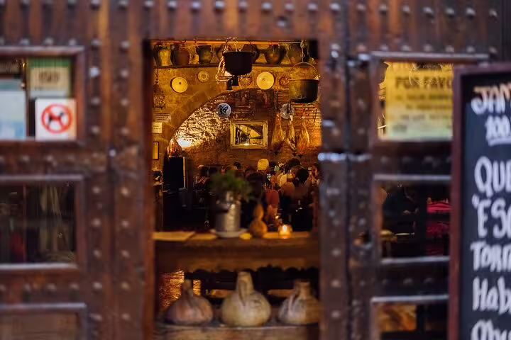 Cozy Spanish tavern interior with rustic decor, perfect for a private tapas and wine walking tour experience.