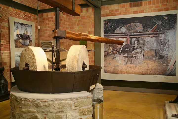 Traditional olive press and millstones exhibit, a stop on the Sparta full day tour in the Peloponnese