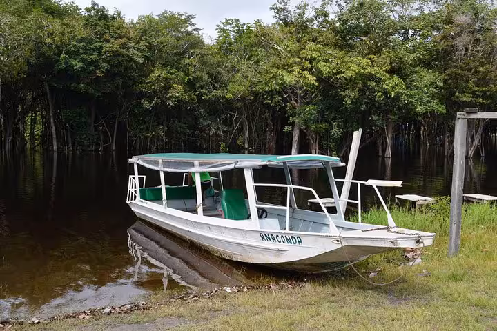 Covered speed boat moored on Amazon riverbank for Santa Rosa to Iquitos Peru border boat ticket
