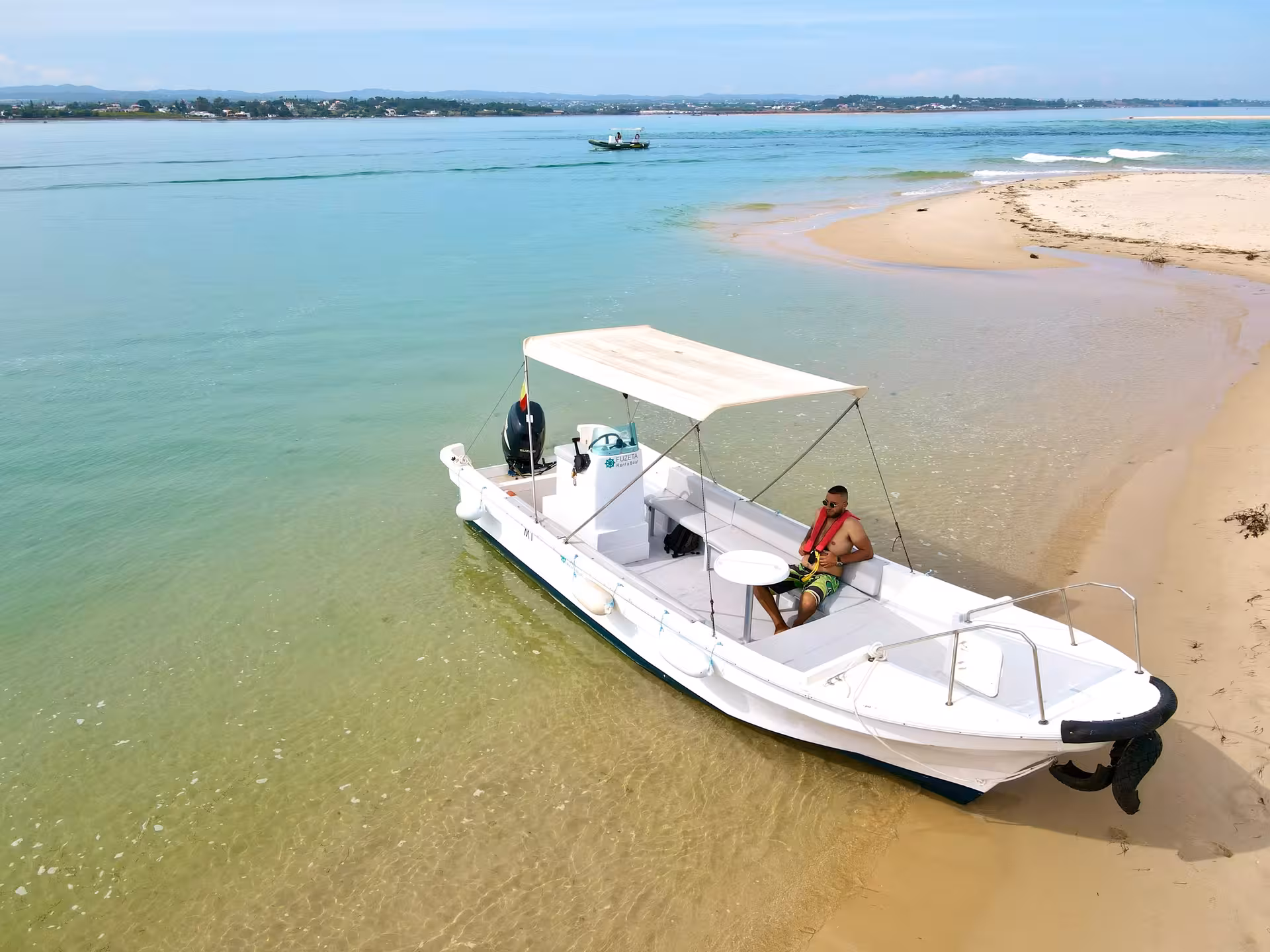 Speed Boat Zurb rental beached on sandy shore in Zurb, Algarve, perfect for private coastal cruising