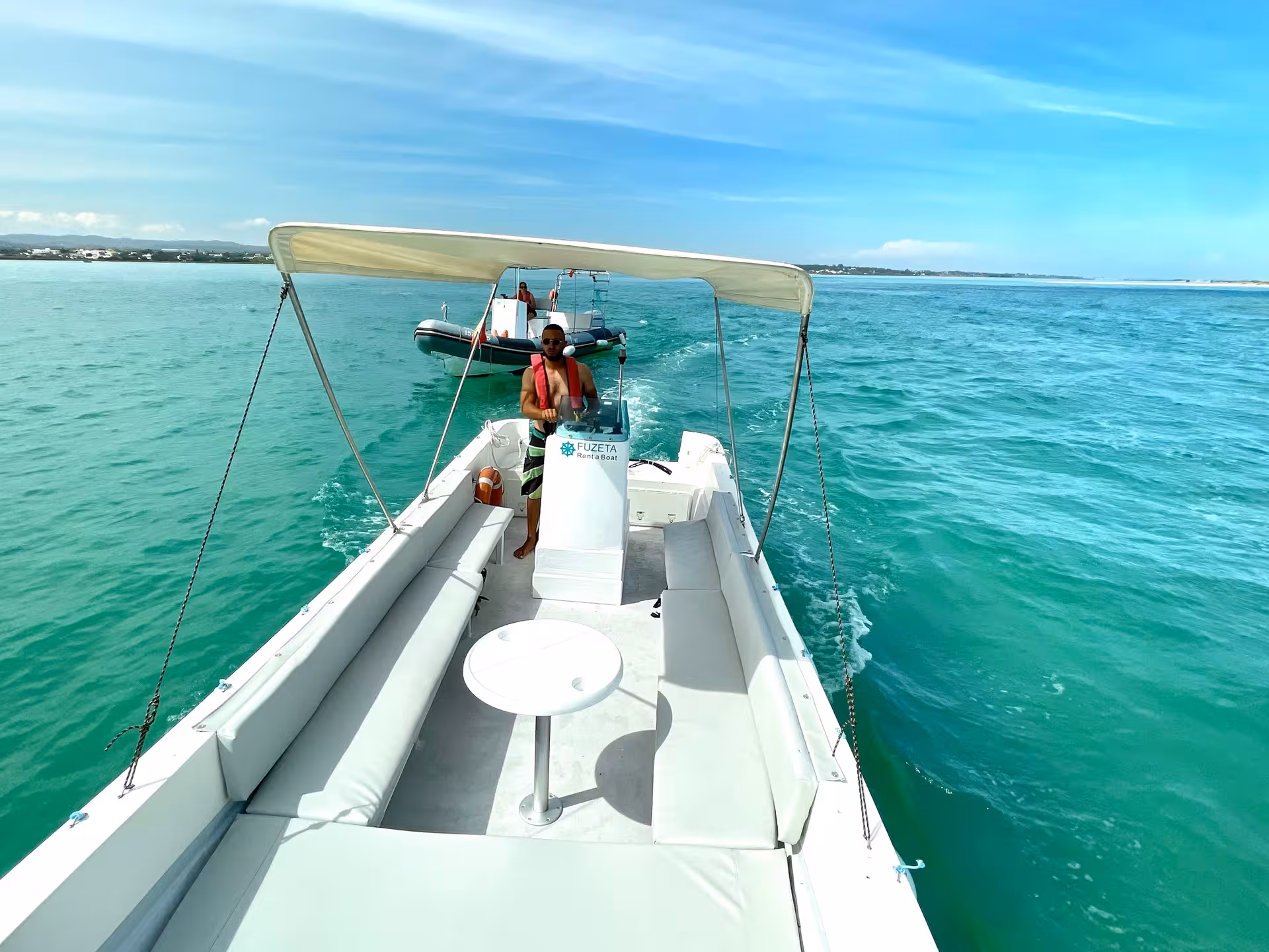 Speed Boat Zurb rent-a-boat cruising turquoise waters near Zurb, Algarve, with shaded canopy and seating