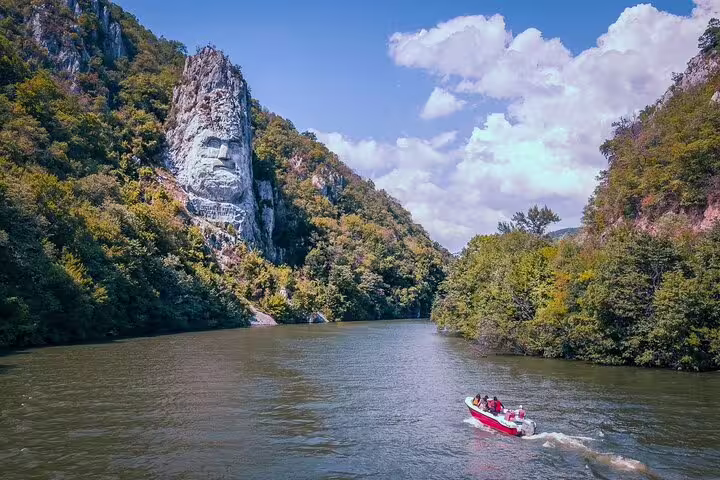 Speedboat on the Danube beneath the Decebalus rock carving in Djerdap Gorge on a private full-day tour