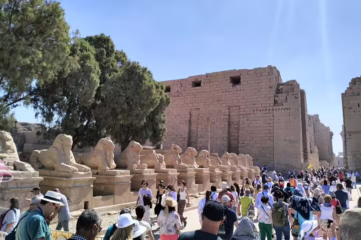 Crowds walking past sphinx statues at Karnak Temple, Luxor, on a 7-day luxury Egypt Nile cruise package