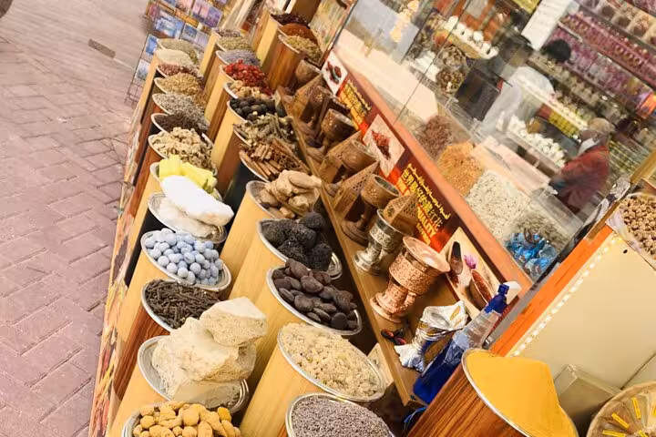 Spice Souk stall in Old Dubai with dried fruits, herbs and snacks on local food tasting walking tour