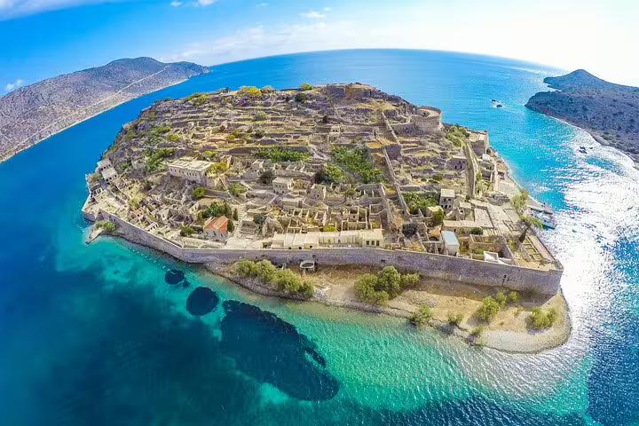 Aerial view of Spinalonga Island's ancient fortress surrounded by turquoise waters, featured in a Chania day tour.