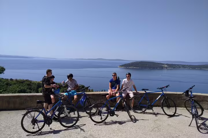 Split City Bike Tour group resting with bikes at viewpoint overlooking Adriatic Sea and Dalmatian islands