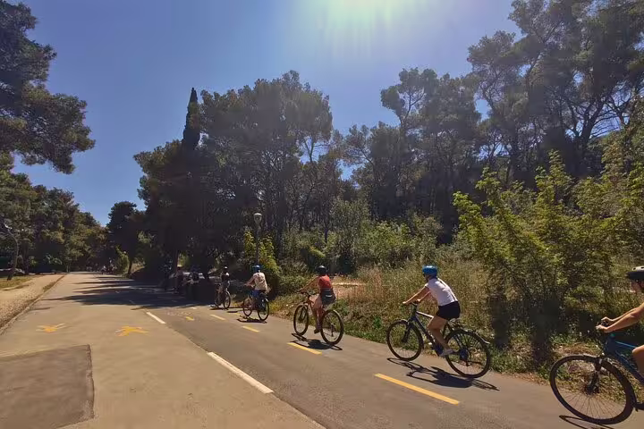 Riders on a sunny park path during Split City Bike Tour, guided cycling through Split green areas and trails
