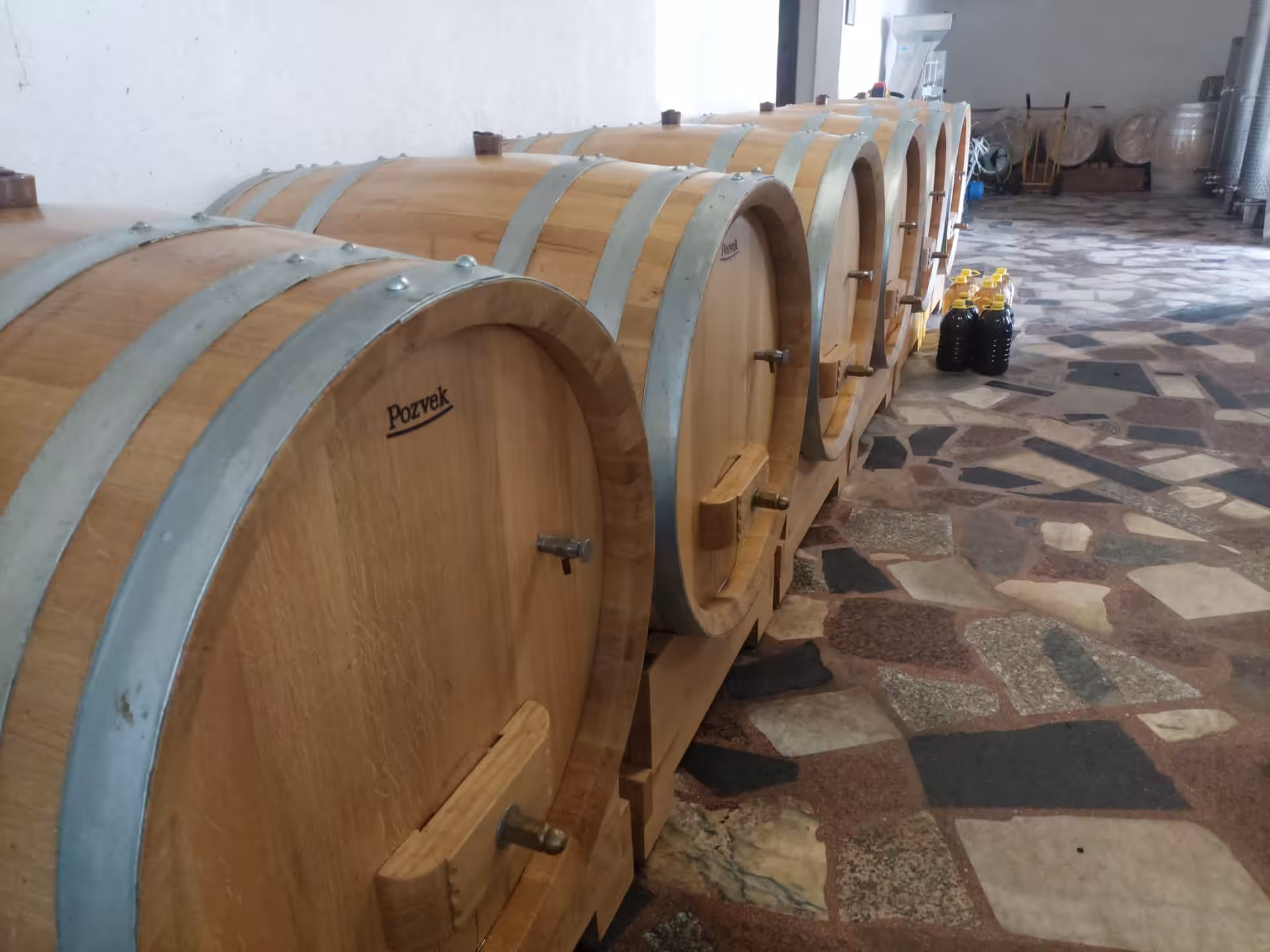 Oak wine barrels aging local Dalmatian vintages for Split to Imotski Lakes wine and dine tasting experience