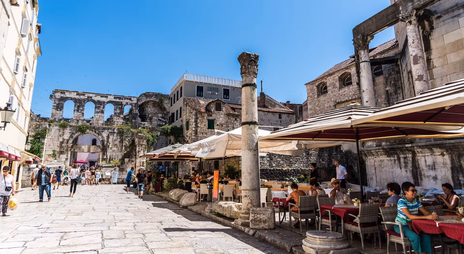 Split Old Town square by Diocletian’s Palace walls and cafes, a stop on the Split history walking tour