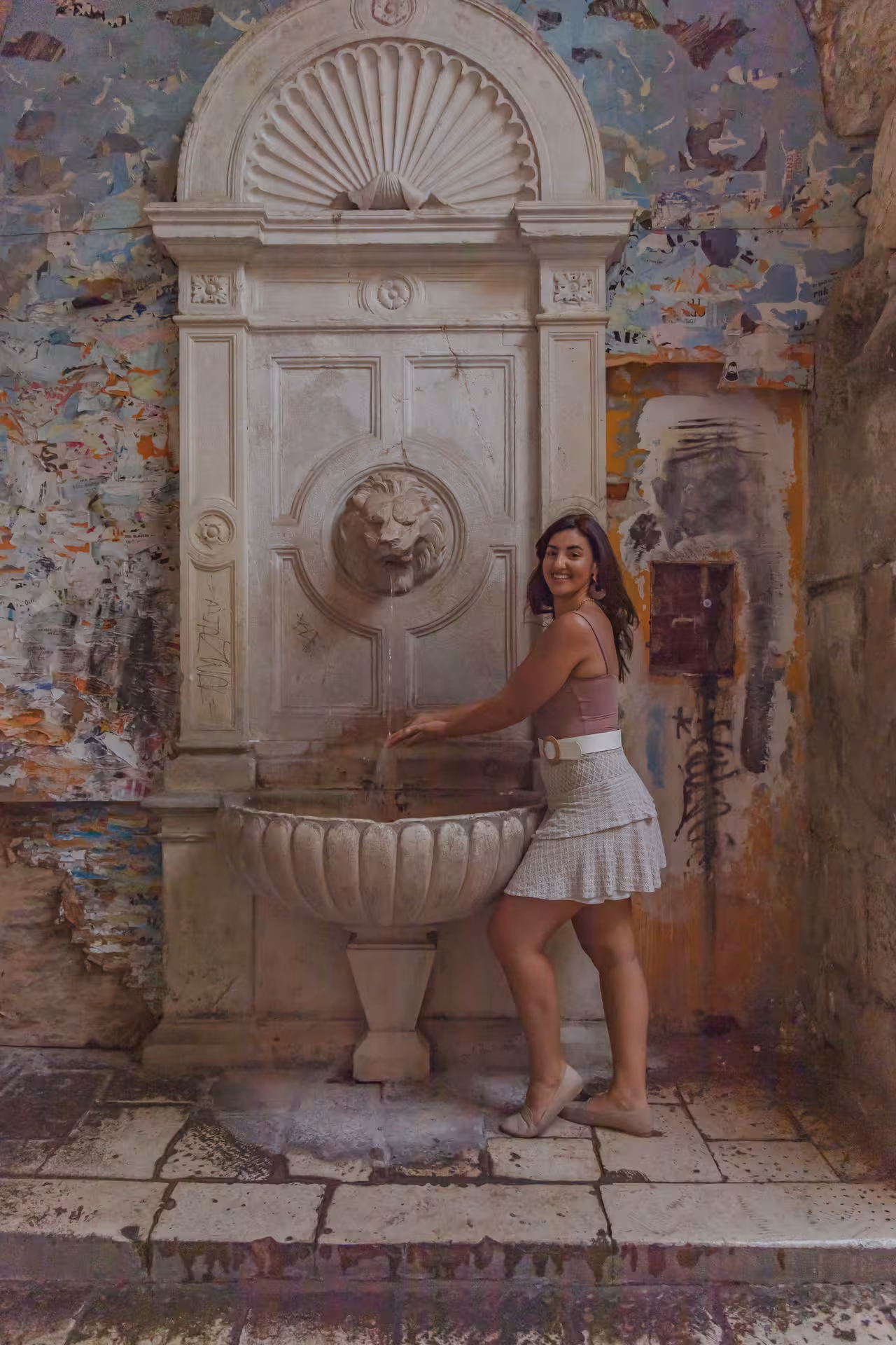 Traveler at a historic stone fountain in Split Old Town, featured stop on the Split history city tour and Klis Fortress