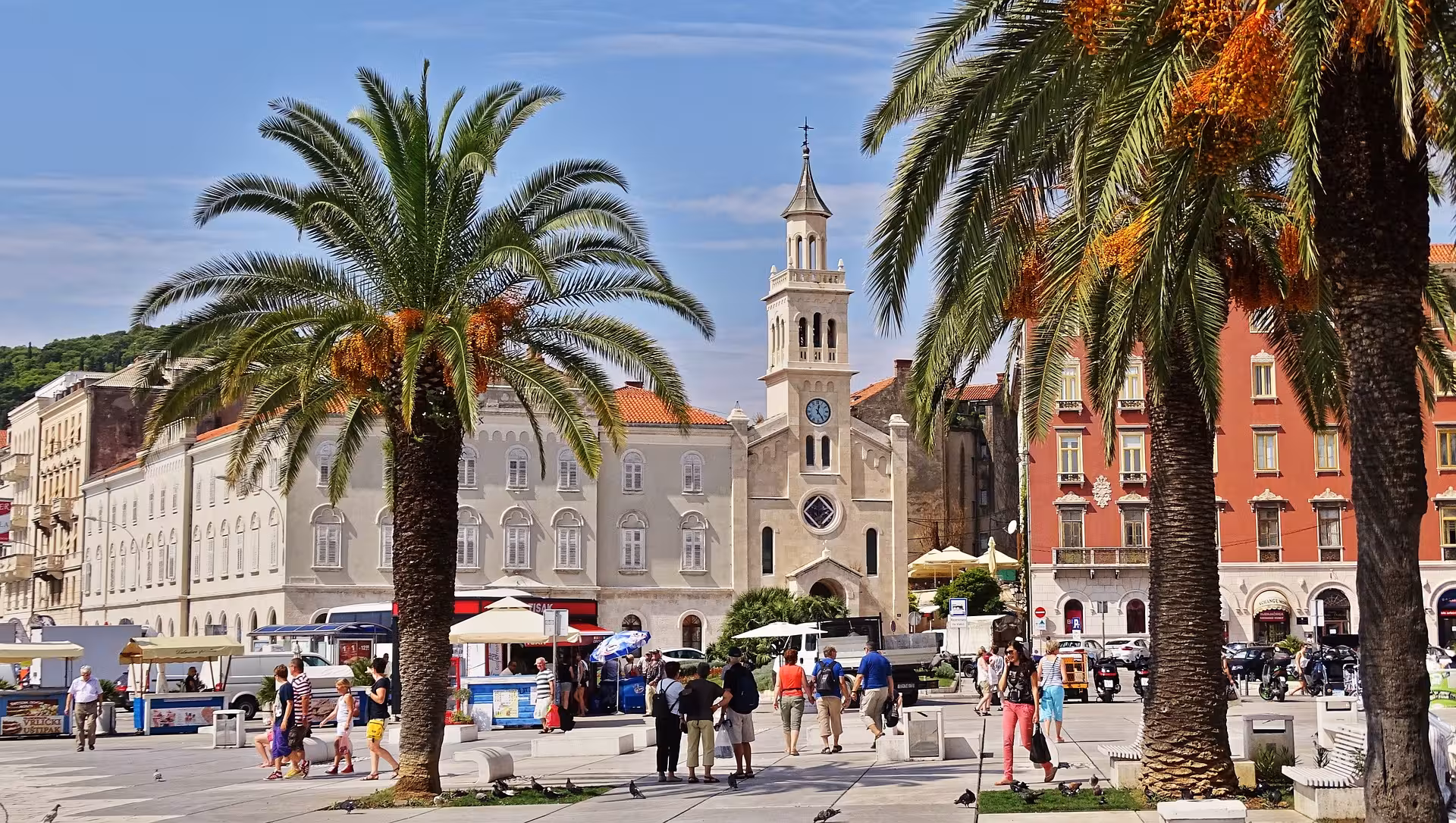 Split Riva promenade with palm trees and historic buildings, lively square on Split city history tour