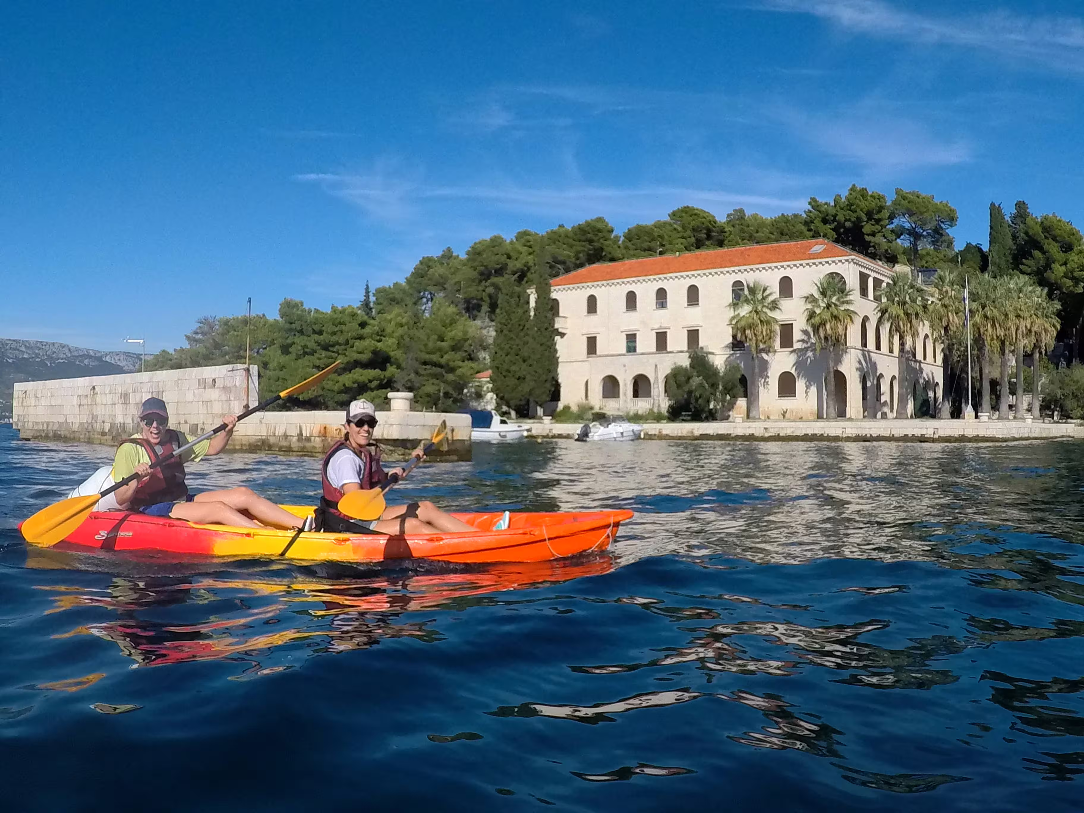 Sea kayaking in Split past a historic waterfront villa, Adriatic guided kayak and snorkeling tour with views