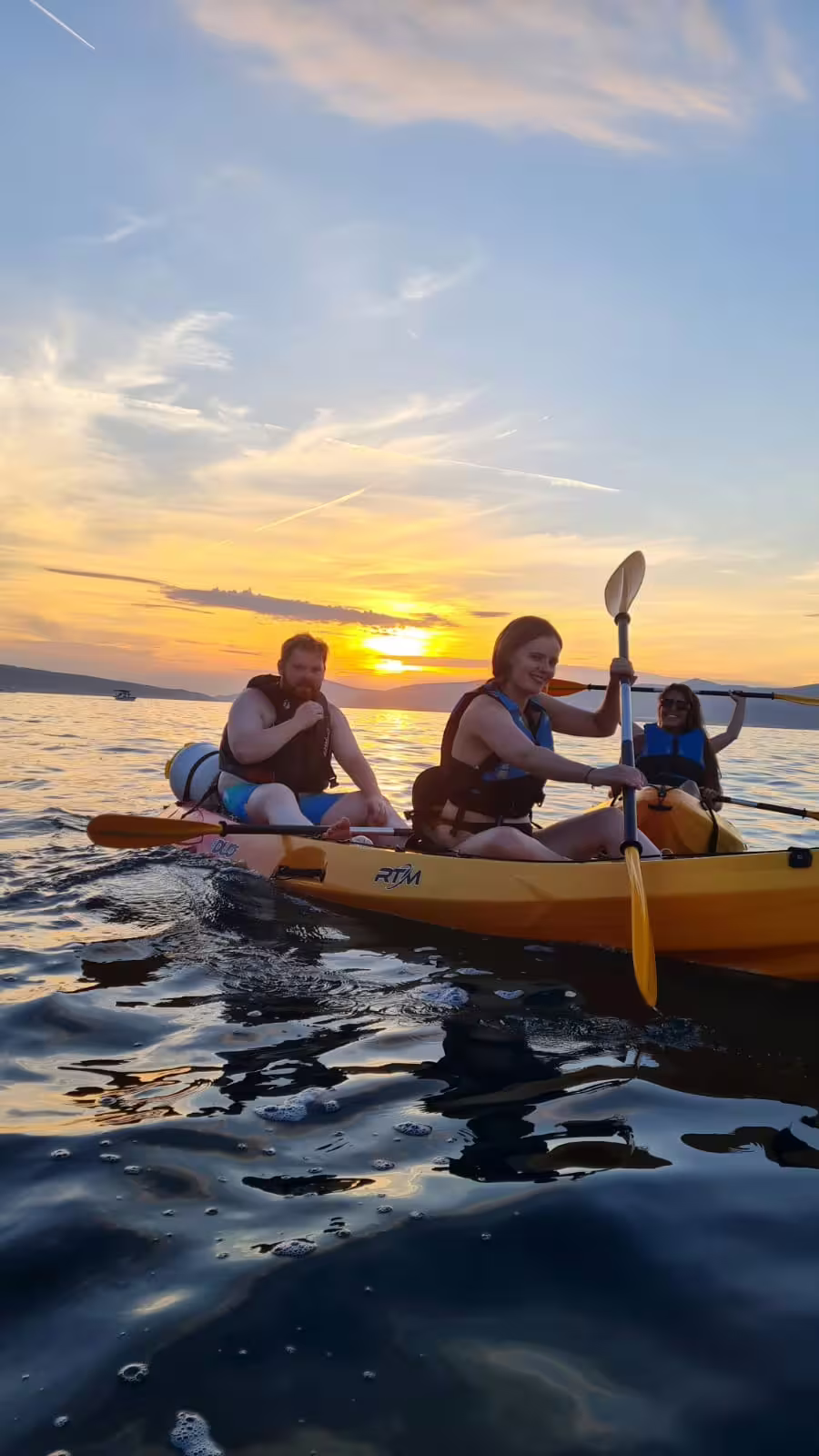 Friends sea kayaking at sunset in Split, Croatia, guided Adriatic paddle tour with wine and coastal views