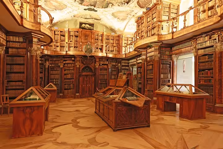 Ornate interior of St. Gallen Abbey Library with historic wooden bookshelves and intricate ceiling frescoes.