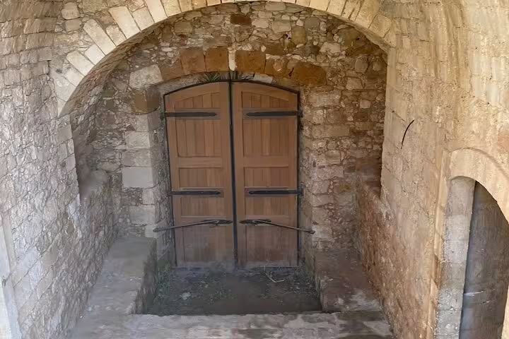 Ancient stone archway entrance at St. Irini Monastery, highlighting historical architecture on a private tour from Chania.