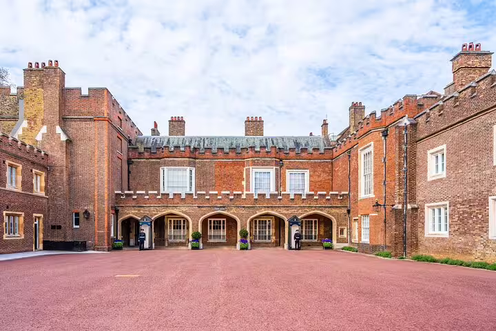 Historic courtyard of St. James's Palace in London, showcasing traditional brick architecture and ceremonial guards.