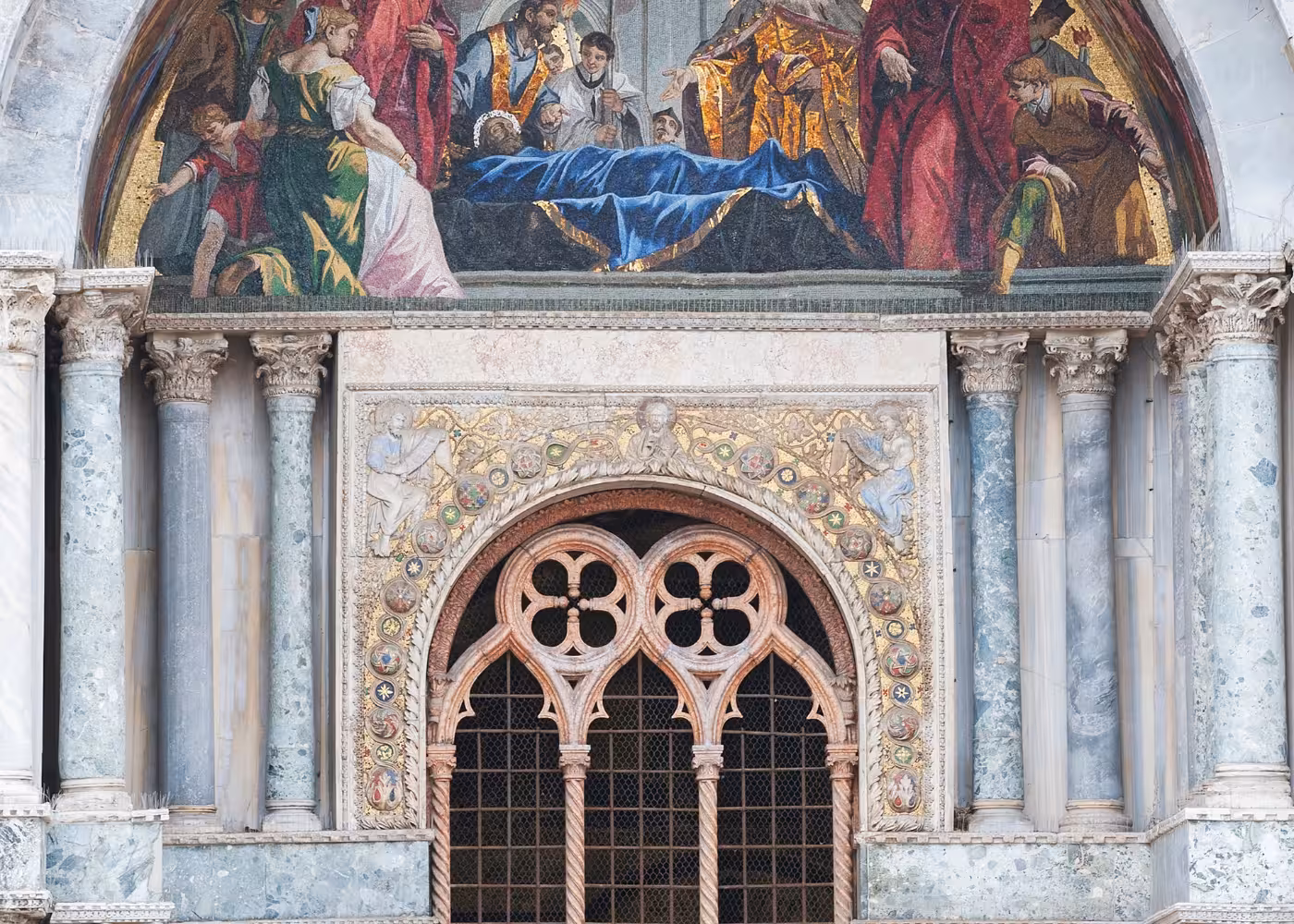 Intricate mosaics and marble arches adorn the facade of St Mark's Basilica, a highlight of the Venice guided tour.