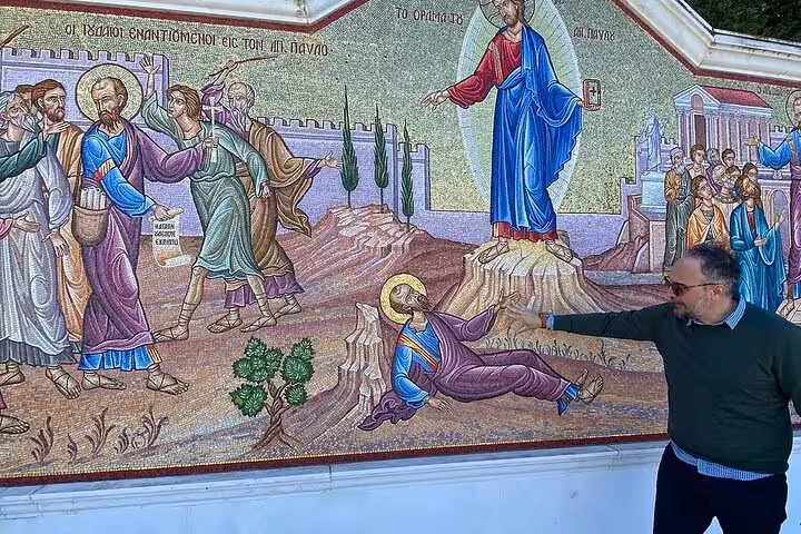 Guide points to St Paul mosaic at Corinth church, key stop on ToThe Corinthians 6-hour biblical tour