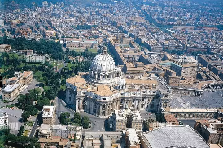 Aerial view of St. Peter's Basilica in Vatican City, showcasing its grandeur, ideal for an underground and dome climb tour.