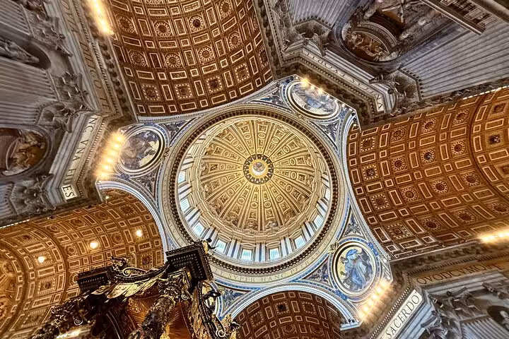 Intricate ceiling of St. Peter's Basilica dome on private Vatican tour, showcasing detailed artistry and architecture.
