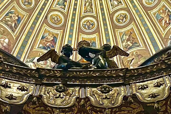 Detail of gilded angels and frescoed dome inside St Peter's Basilica seen on VIP early morning climb the dome private tour