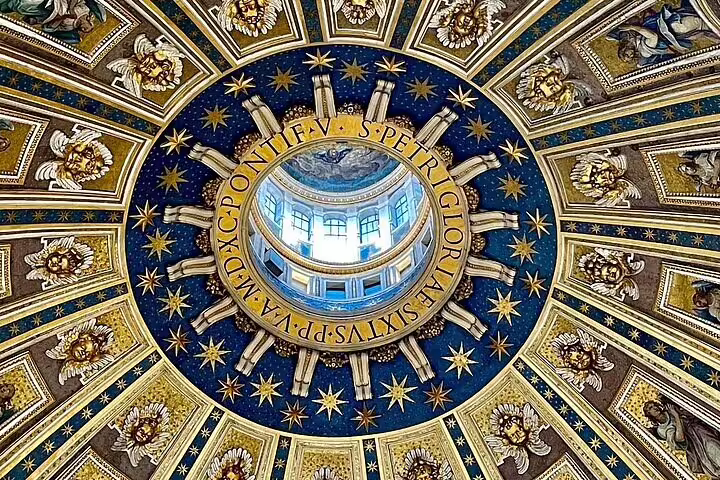 Close-up of richly decorated St Peter’s Basilica dome oculus and starry ceiling, experienced on a VIP early morning climb