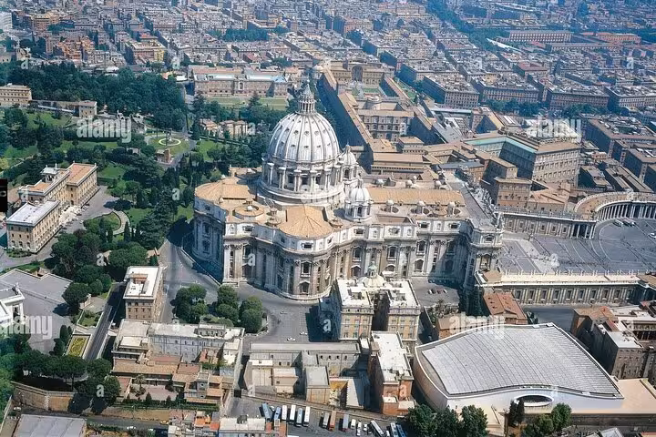 Overhead image of St. Peter's Basilica, showcasing the grand dome and sprawling Vatican City landscape.